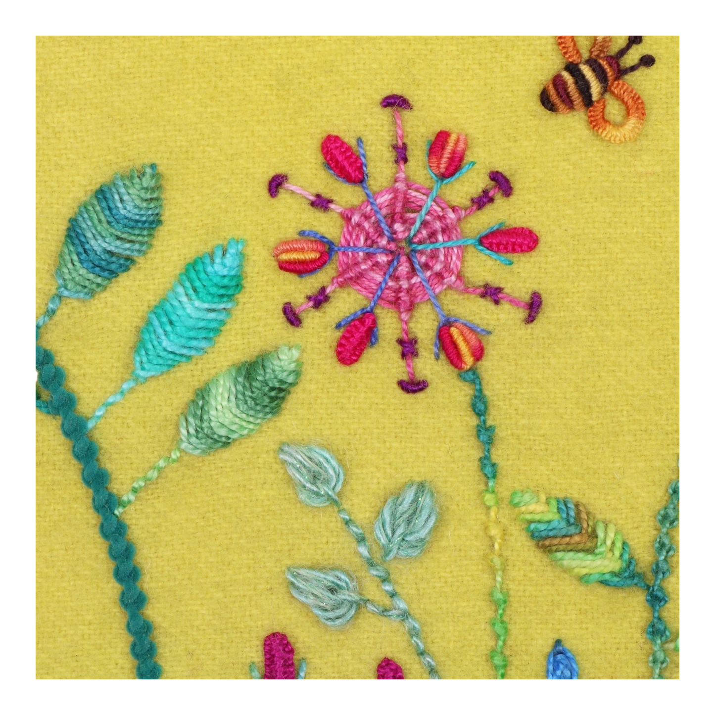 Everything Fabric embroidery sample featuring dimensional raised leaf stitches and floral designs on yellow fabric