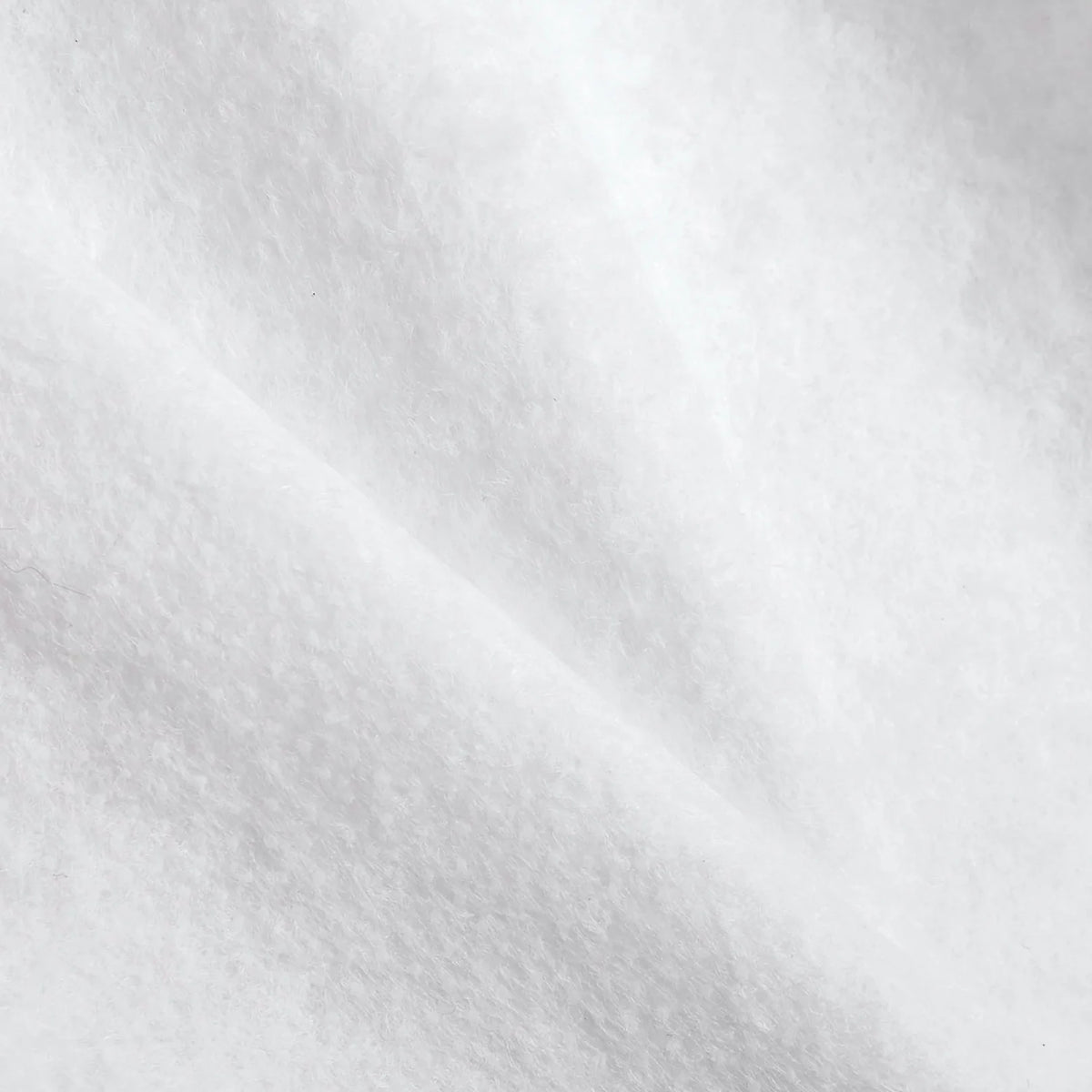 Parlan white non-woven fusible wadding by Charles Parsons, 100 cm wide, showing its soft felt-like texture
