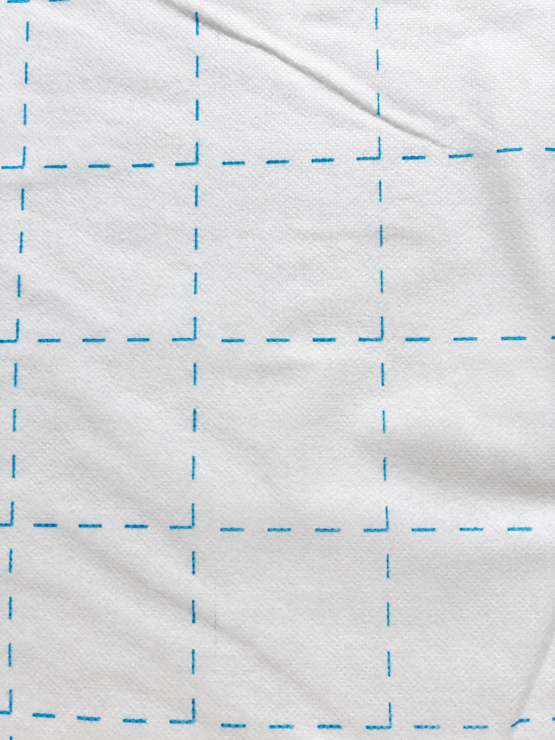 Bosal Quilter's Grid 2-inch fusible interfacing — single layer showing blue grid on white