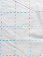 Bosal Quilter's Grid 2-inch fusible interfacing — single layer showing blue grid on white