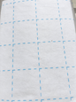 Bosal Quilter's Grid 2.5-inch fusible interfacing — single layer showing blue grid on white