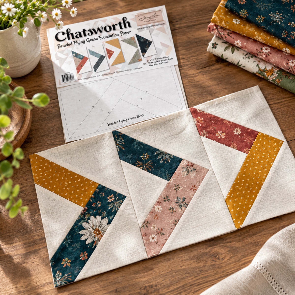 Illustrative project idea: Chatsworth Braided Flying Geese Quilt Block Foundation Paper Pad. Styling materials not included.